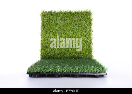 Grass mat on white background. Artificial turf tile background. Object and background concept. Stock Photo