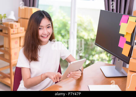 Asian Woman Using Tablet With Parcel Boxes In Delivery Service Theme Part Time And Lifestyle Concept Stock Photo Alamy