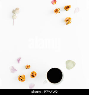 Feminine workspace pattern with cup of coffee and dry roses on white background. flat lay, top view Stock Photo
