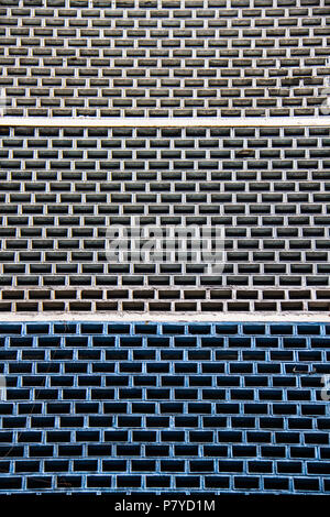 Building wall made of hollow white and blue concrete bricks. Stock Photo