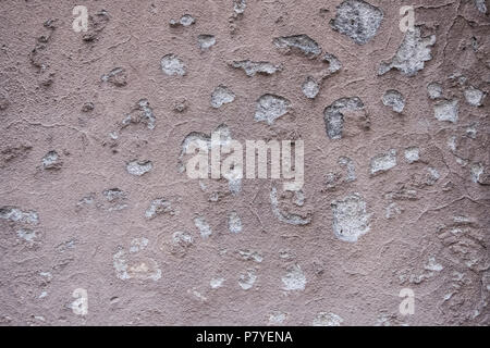 Old and decayed salmon paint concrete wall. Stock Photo