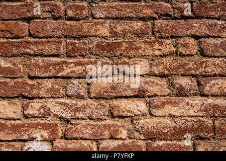 Old and worn red brick wall. Stock Photo