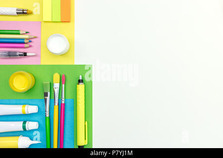 pencils, highlighters, brushes, erasers and colored album paper on white background Stock Photo