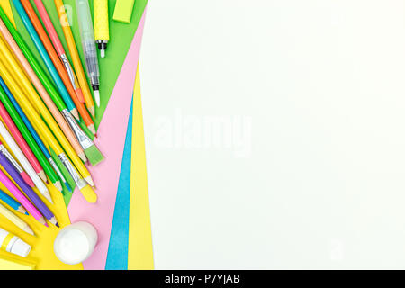 colored pencils, paints, markers, eraser, colored paper on white background. flat view Stock Photo