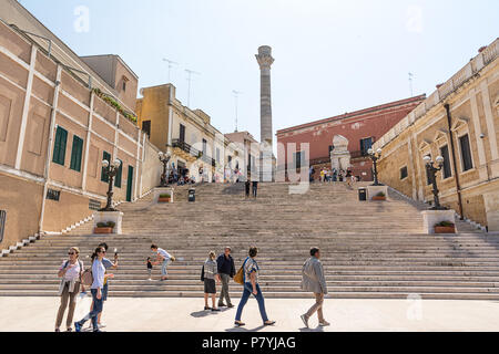 Brindisi, Italy - April 30, 2018: Terminal columns of the ancient Via Appia that begins in Rome and ends in Brindisi (Italy) and tourists visiting Stock Photo