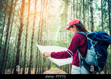 Female tourist travel in pine woods trip hiking during vacation. Travel and Wild nature concept. Lifestyle and activities of woman. People and outdoor Stock Photo