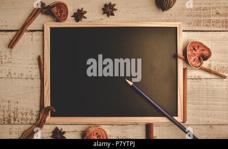 School empty wooden blackboard on wooden floor with pencil and dry leaves. Education and Nature concept. Back to school theme. Top view and flat lay Stock Photo