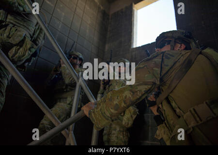 Australian soldiers, with Task Group Taji’s quick reaction force, demonstrate building clearance drills during concurrency training with U.S. Soldiers of Bandit Troop, 3rd Calvary Regiment at Camp Taji, Iraq, June 11, 2018. A Coalition created from a diverse international community will continue its support to the people of Iraq in order to enhance the capabilities of the nation to ensure security and stability. (U.S. Army photo by Spc. Audrey Ward) Stock Photo