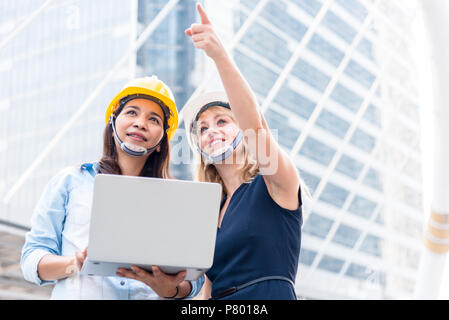Two women engineering surveying for startup and launching new project. Building and construction concept. Business and happiness of cooperation concep Stock Photo