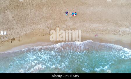 Aerial view of alone colorful umbrella on the beach. Holiday concept top view. Stock Photo