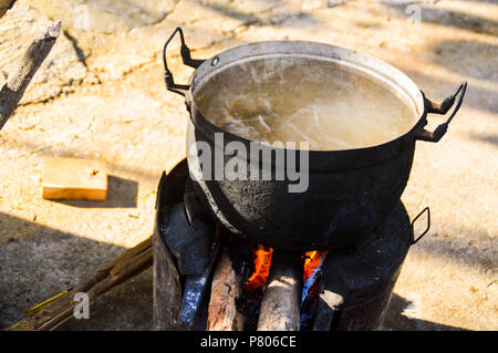 Traditional open fire cooking using wood as fuel and is common all over southeast asian countries specially in villages like this one in Muang ngoy, Luang Prabang Laos Stock Photo