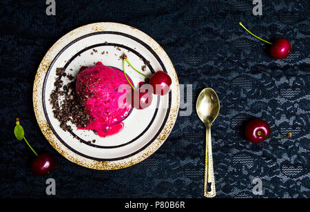 Cherry ice cream scoops on a plate top view Stock Photo