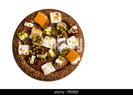 Various Turkish delights on a copper plate isolated on white Stock Photo