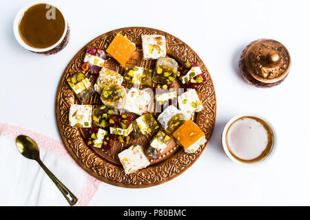Various Turkish delights on a copper plate isolated on white Stock Photo