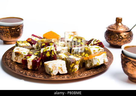 Various Turkish delights on a copper plate isolated on white Stock Photo
