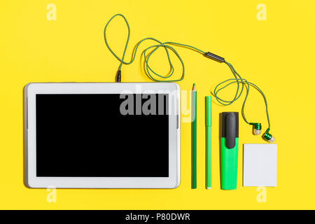 office stationary and gadgets on a yellow surface Stock Photo