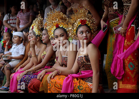 Tenganan, Indonesia – June 30 2018: Local girls with ornate gold head-dresses in the village of Tenganan, Bali during the annual Perang Pandan festiva Stock Photo