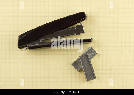 black stapler with paper clips shot close-up Stock Photo