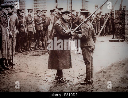 With the outbreak of World War 1, King George V crossed to France in November 1914 and spent several days with the troops. He decorated a soldier in the presence of Sir Douglas Haig, commander of the 1st Army Corps. Stock Photo