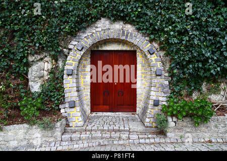 Horseshoe shaped doorway in stone wall, Vila Praia de Ancora, Minho Province, northern Portugal Stock Photo