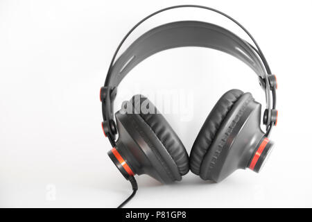 modern studio headphones, black with small red list on white background Stock Photo