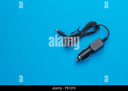 Car Charger Car Adapter for Cigarette Lighter isolated on blue background Stock Photo