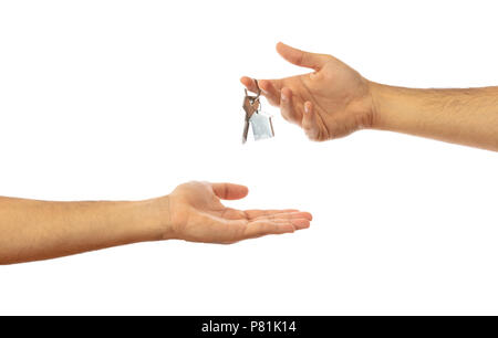 Handing over the house key. Male hands isolated on white background, clipping path Stock Photo