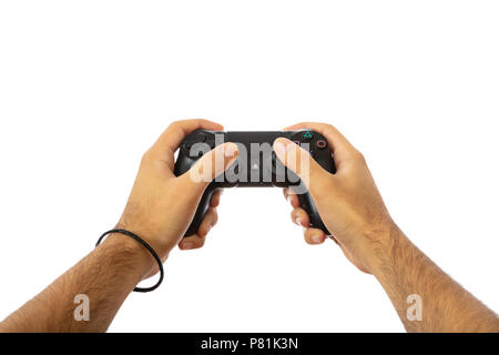 Playing video games. Male hands holding a video game controller isolated on white background, clipping path Stock Photo