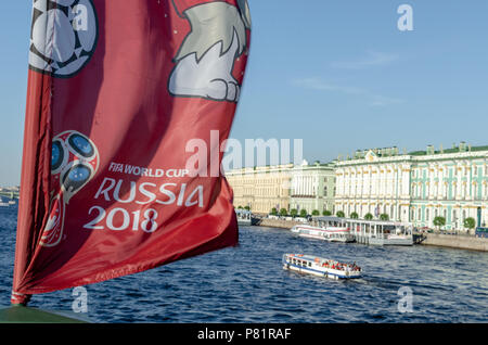 Flag with the official Russia 2018 world cup mascot and logo on the Neva river overlooking the Winter Palace in St Petersburg. Stock Photo