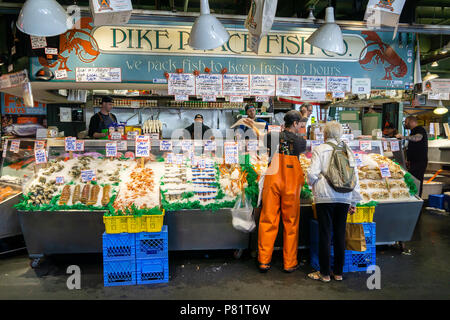 Fish merchants selling fish at Pike Place market, historic and iconic covered market of Seattle, WA, USA. Stock Photo