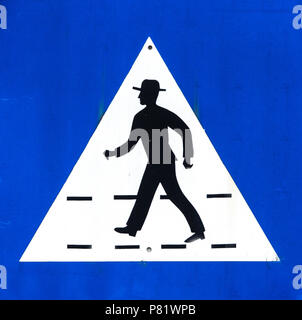 Pedestrian crossing sign, black silhouette of hatted man on blue background, Portugal, close-up Stock Photo
