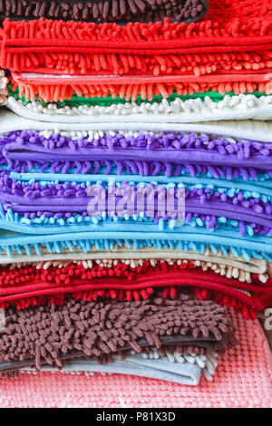 Pile of colorful bathroom floor mats and foot towels Stock Photo