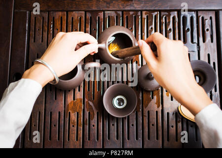 Tea ceremony, woman cleaning tea equipment with a brush first person view Stock Photo