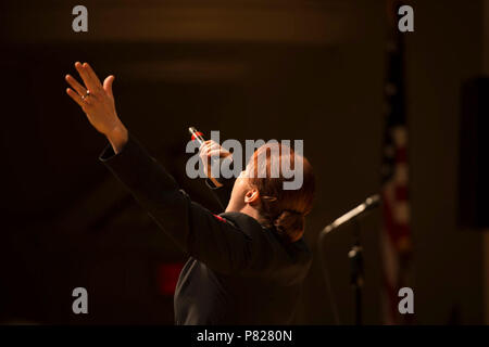 EDINBORO, PA (April 5, 2016) Musician 1st Class Maia Rodriguez sings with the United States Navy Band Sea Chanters chorus during a concert at Edinboro University. The Sea Chanters are on a 22-day tour of the northeastern United States. Stock Photo