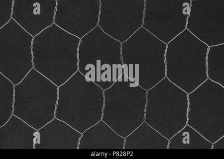 Hexagon shape metal fence on black background surface Stock Photo