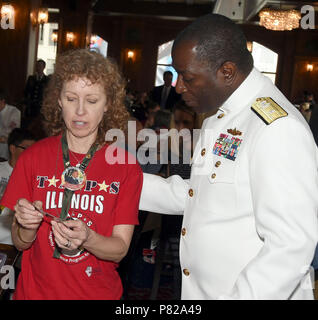 CHICAGO (May 28, 2016) Rear Adm. Stephen C. Evans, commander of Naval Service Training Command (NSTC), talks with Nancy Ebbers, the mother of U. S. Army Pvt. James Henry Ebbers, from Oak Lawn, Illinois, during a Gold Star Family breakfast in the Walnut Room of Macy’s Department Store before the Chicago Memorial Day Parade here, May 28. Ebbers died during Operation Enduring Freedom in 2002. Evans joined Chicago Mayor Rahm Emanuel, U. S. government representatives and military flag and senior officers to commemorate the day and remember service members who gave the ultimate sacrifice during thei Stock Photo