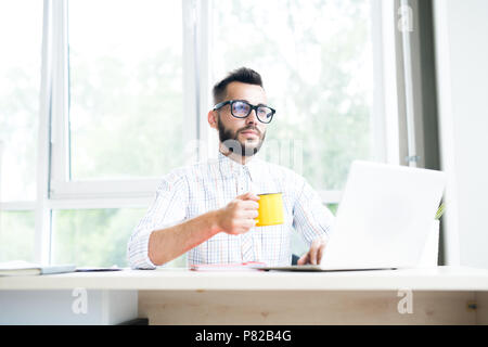 Pensive Entrepreneur Working in Office Stock Photo