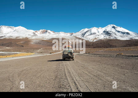 4WD Toyota car driving through the picturesque landscape of The Eduardo Abaroa Andean Fauna National Reserve in Bolivia. Stock Photo