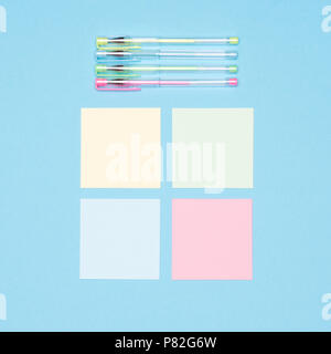 Creativity flat lay. Top view of set of sticky notes and colorful pens on pastel blue colored background. Creative occupation, designer workspace. Stock Photo
