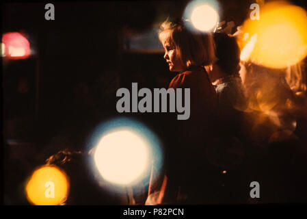 At Christmas in 1980, a little girl watches a school nativity play from the audience. A fast colour slide film made for tungsten lights, 3M 640T, allo Stock Photo