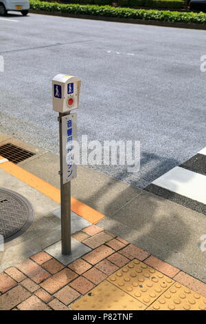 TOKYO JAPAN - MAY 2018 : pedestrian signal button for blind people, japanese text mean 'Press button for acoustic' Stock Photo