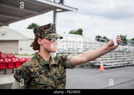 Candidates with Lima Company, Officer Candidate School (OCS), are evaluated in close order drill aboard Marine Corps Base Quantico, Va., August 3, 2016. The mission of OCS is to educate and train officer candidates in order to evaluate and screen individuals for qualities required for commissioning as a Marine Corps officer. Stock Photo