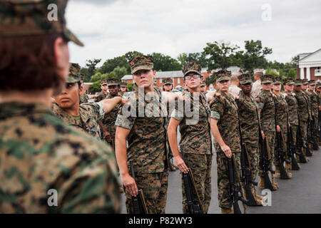 Candidates with Lima Company, Officer Candidate School (OCS), are evaluated in close order drill aboard Marine Corps Base Quantico, Va., August 3, 2016. The mission of OCS is to educate and train officer candidates in order to evaluate and screen individuals for qualities required for commissioning as a Marine Corps officer. Stock Photo