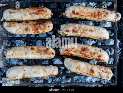 Sausages being cooked on a BBQ, barbecue. Stock Photo