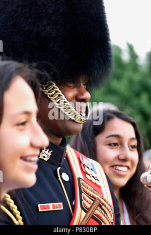 Arlington, Virginia, USA - June 13, 2018: Tourists pose with CW2 Jac’kel Smalls of the U.S. Army Band  'Pershing's Own' after a Twilight Tattoo. Stock Photo