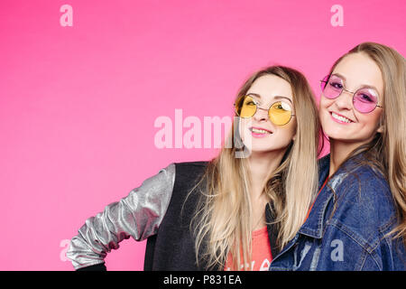 Stylish hipster girls in colorful sunglasses happy smiling. Stock Photo