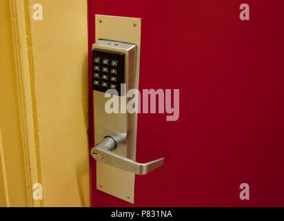 A keypad on a door is batter operated, punch in a code and it will open Stock Photo