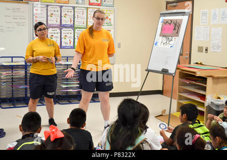 HOUSTON (Oct. 18, 2016) Petty Officer 1st Class Cynthia Martens, right, and Seaman Jade Alvarado from USS George H.W. Bush (CVN 77) talk to children about Navy life at the Housman Boys and Girls Club in Houston, Texas, during Navy Week.  Navy Weeks, coordinated by the Navy Office of Community Outreach (NAVCO), are designed to give Americans the opportunity to learn about the Navy, its people and its importance to national security and prosperity. Stock Photo