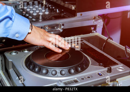DJ hands and remote and mixer DJ for music Stock Photo