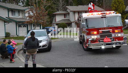 SILVERDALE, Wash. (Dec. 18, 2016) – Residents at Naval Base Kitsap (NBK) – Bangor family housing greet Santa Claus’ arrival on a Navy Region Northwest (NRNW) Fire and Emergency Services truck. Santa and his helpers delivered candy to NBK residents at Bangor and Jackson Park. Stock Photo